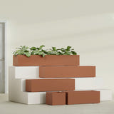 Cuba Low Rectangular fiberglass planter in Matte Terra Cotta, size range, in a sunlit interior