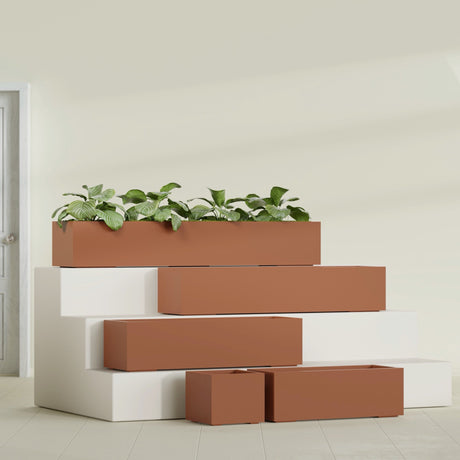 Cuba Corner fiberglass planter in Matte Terra Cotta, size range, in a sunlit interior