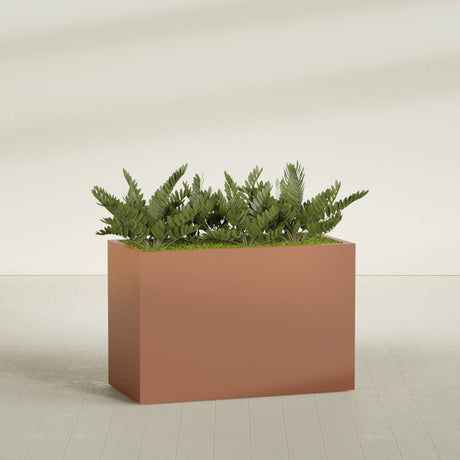 Brisbane Rectangular fiberglass planter in Matte Terra Cotta, shown planted, in a sunlit interior