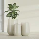 Hayden Urn fiberglass planter in Satin Beige, size range, in a sunlit interior