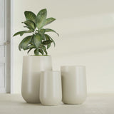 Hayden Urn fiberglass planter in Satin Beige, size range, in a sunlit interior