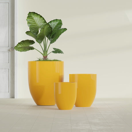 Valencia Tapered Round fiberglass planter in Gloss Saffron, size range, in a sunlit interior