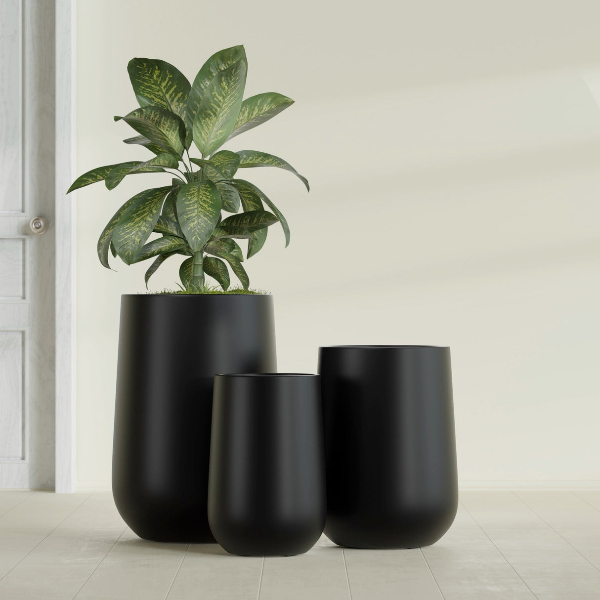Hayden Urn fiberglass planter in Matte Black, size range, in a sunlit interior