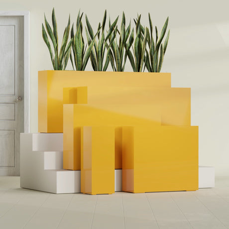 Delray Corner fiberglass planter in Gloss Saffron, size range, in a sunlit interior