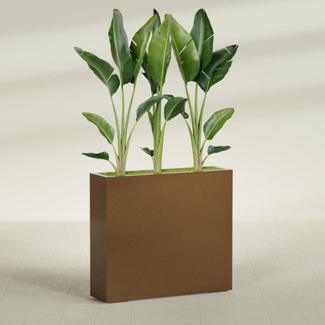 Amesbury Narrow Rectangular fiberglass planter in Metallic Bronze, shown planted, in a sunlit interior