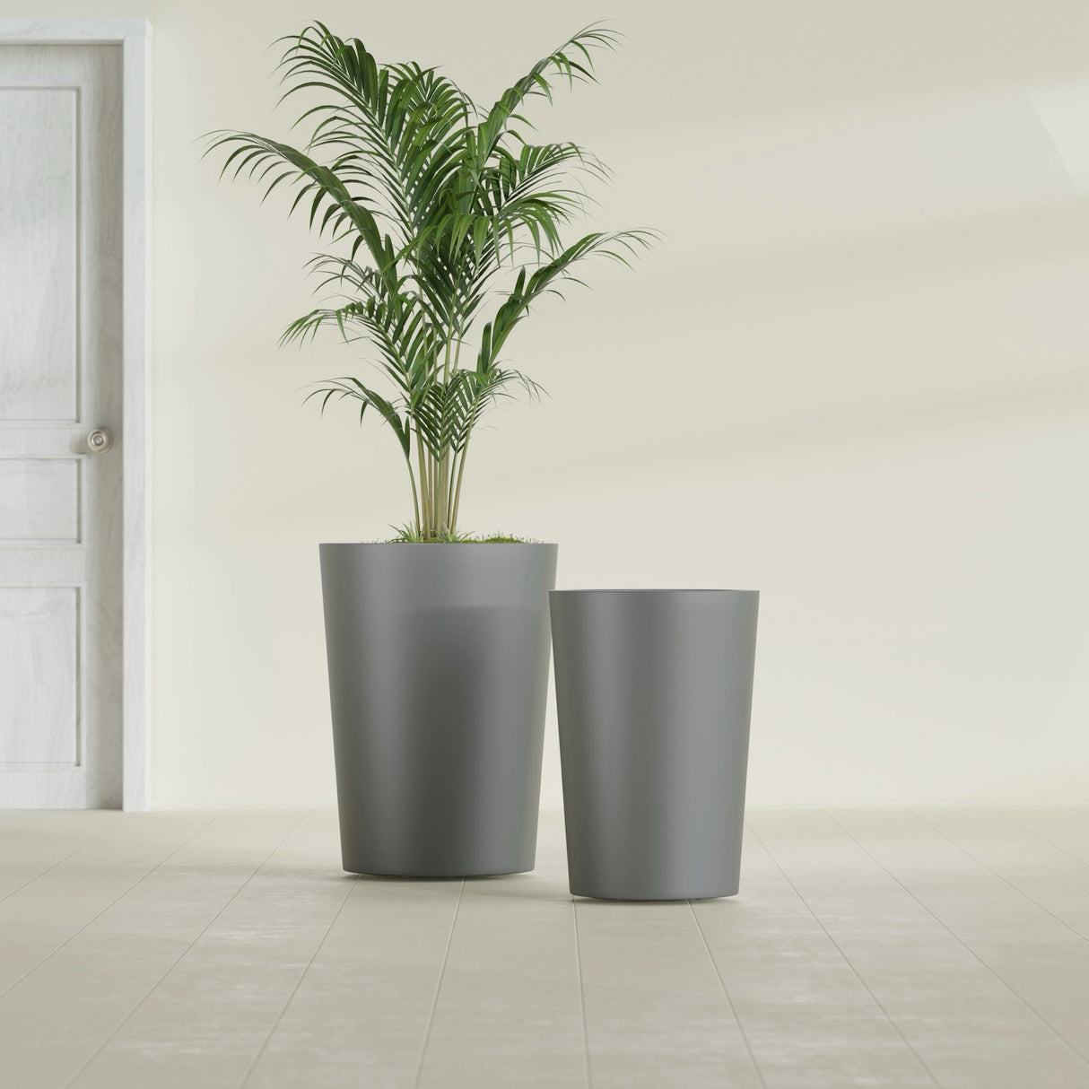 Tegel Round Tapered fiberglass planter in Matte Gunmetal, size range, in a sunlit interior