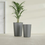 Tegel Round Tapered fiberglass planter in Matte Gunmetal, size range, in a sunlit interior