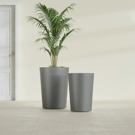 Tegel Round Tapered fiberglass planter in Matte Gunmetal, size range, in a sunlit interior