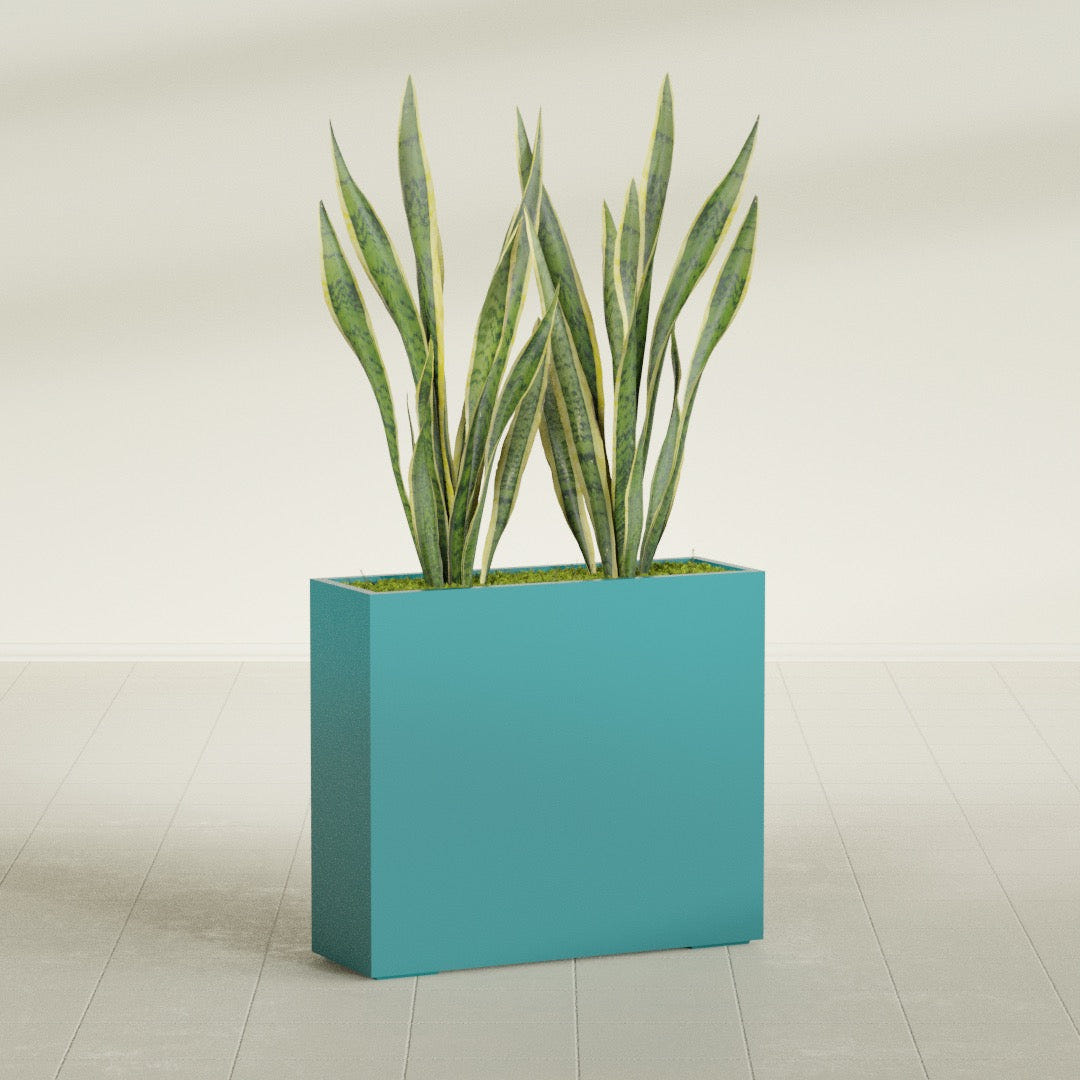 Perth Rectangular fiberglass planter in Satin Seafoam Green, shown planted, in a sunlit interior