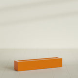 Salon Box Planter in Gloss Tangerine, 42" Long, shown empty