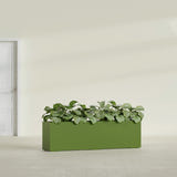 Hudson Extra Long fiberglass planter in Satin Green, shown planted, in a sunlit interior
