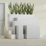 Delray Corner fiberglass planter in Metallic Silver, size range, in a sunlit interior