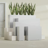 Delray Corner fiberglass planter in Metallic Silver, size range, in a sunlit interior