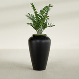 Barà Jar fiberglass planter in Matte Black, shown planted, in a sunlit interior