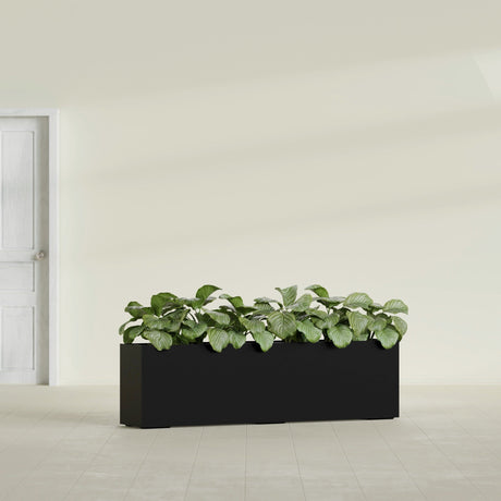 Hudson Extra Long fiberglass planter in Matte Black, shown planted, in a sunlit interior