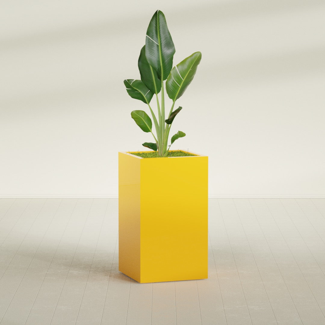 Darwin Corner fiberglass planter in Gloss Saffron, shown planted, in a sunlit interior