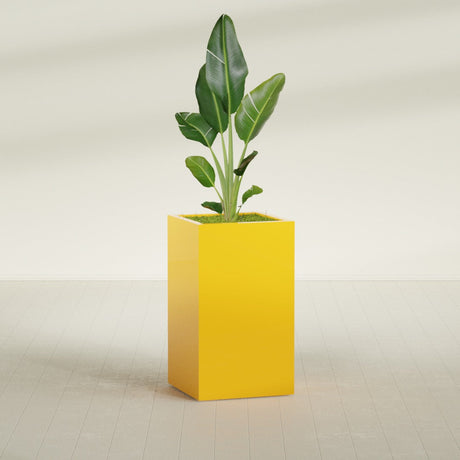 Darwin Corner fiberglass planter in Gloss Saffron, shown planted, in a sunlit interior