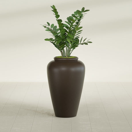 Barà Jar fiberglass planter in Matte Dark Brown, shown planted, in a sunlit interior