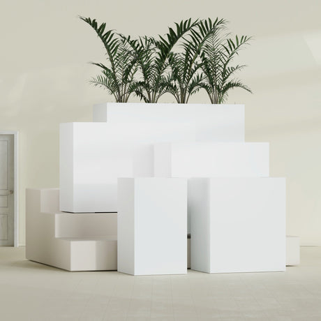 Darwin Corner fiberglass planter in Matte Bright White, size range, in a sunlit interior