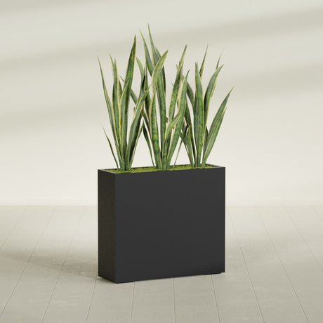 Delray Corner fiberglass planter in Matte Black, shown planted, in a sunlit interior