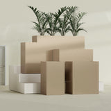 Darwin Corner fiberglass planter in Gloss Metallic Gold, size range, in a sunlit interior