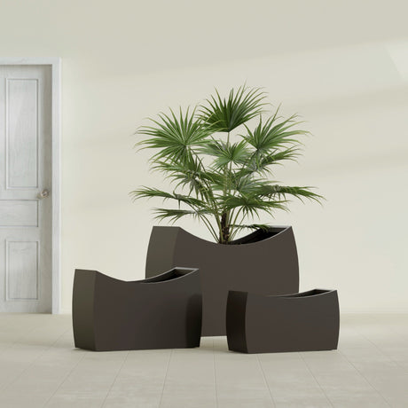 Seoul Curved fiberglass planter in Matte Dark Brown, size range, in a sunlit interior