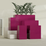 Darwin Corner fiberglass planter in Gloss Eggplant, size range, in a sunlit interior