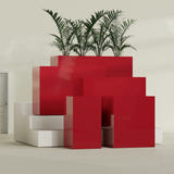 Darwin Corner fiberglass planter in Gloss Red, size range, in a sunlit interior
