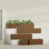 Cuba Low Rectangular fiberglass planter in Metallic Bronze, size range, in a sunlit interior