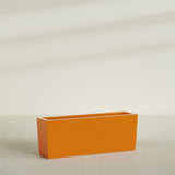 Panama Tapered Rectangular Planter in Gloss Tangerine, 48"L × 12"D × 18"H, shown empty