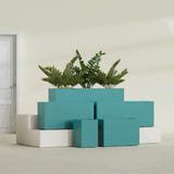 Tolga Rectangular fiberglass planter in Satin Seafoam Green, size range, in a sunlit interior