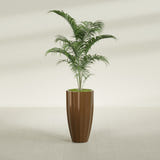 San Jose Tall Fluted fiberglass planter in Metallic Bronze, shown planted, in a sunlit interior
