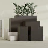 Darwin Corner fiberglass planter in Matte Dark Brown, size range, in a sunlit interior