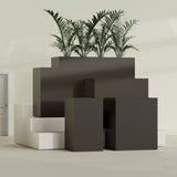 Darwin Corner fiberglass planter in Matte Dark Brown, size range, in a sunlit interior