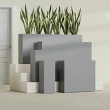 Delray Corner fiberglass planter in Matte Gunmetal, size range, in a sunlit interior