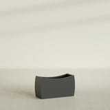 Seoul Curved Planter in Matte Charcoal, 32"L × 12"D × 18"H, shown empty