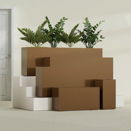 Hollywood Corner fiberglass planter in Metallic Bronze, size range, in a sunlit interior