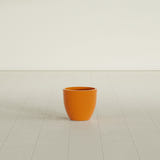 Wannsee Round Planter in Gloss Tangerine, 15"D × 13"H, shown empty