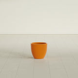 Wannsee Round Planter in Gloss Tangerine, 15"D × 13"H, shown empty