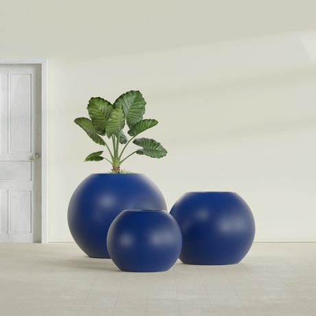 Globe fiberglass planter in Matte Cobalt Blue, size range, in a sunlit interior