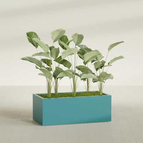 Torino Corner fiberglass planter in Satin Seafoam Green, shown planted, in a sunlit interior