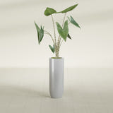 Saint Tropez Bullet Round fiberglass planter in Metallic Silver, shown planted, in a sunlit interior