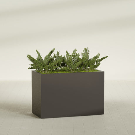Brisbane Corner fiberglass planter in Matte Dark Brown, shown planted, in a sunlit interior