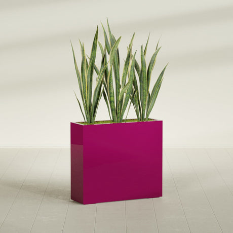Delray Corner fiberglass planter in Gloss Eggplant, shown planted, in a sunlit interior