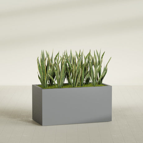 Granada fiberglass planter in Matte Gunmetal, shown planted, in a sunlit interior