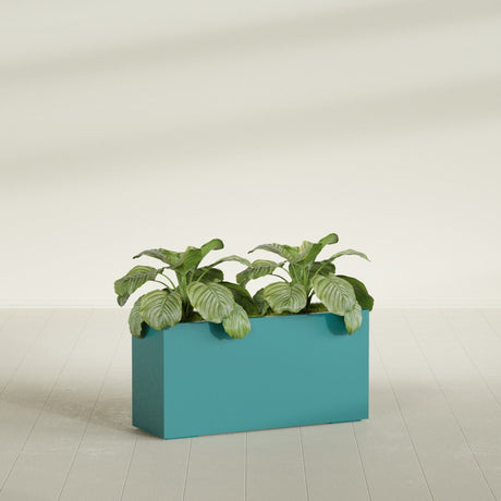 Miami Corner fiberglass planter in Satin Seafoam Green, shown planted, in a sunlit interior