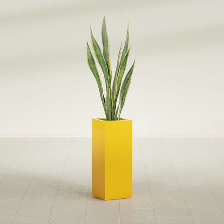 Perth Corner fiberglass planter in Gloss Saffron, planted, in a sunlit interior