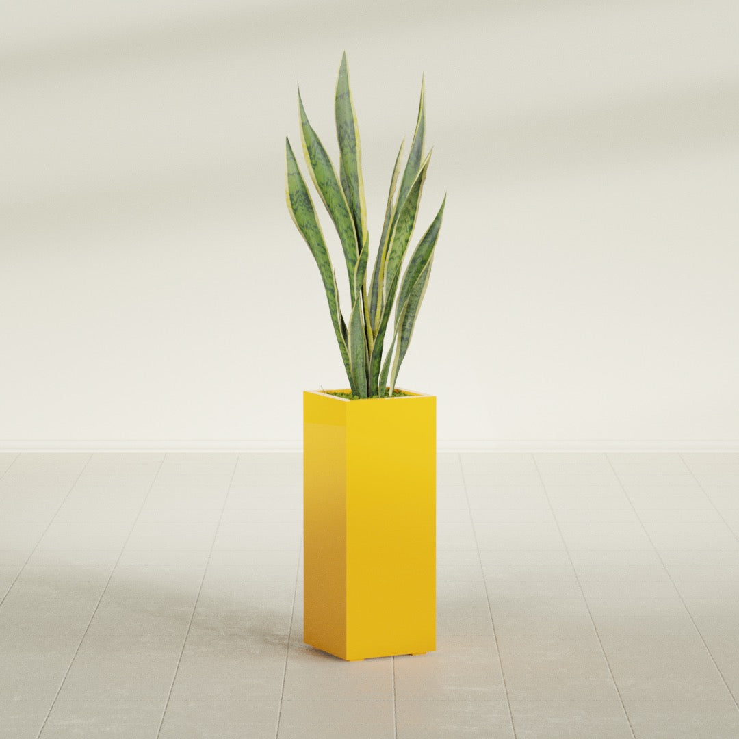 Perth Corner fiberglass planter in Gloss Saffron, planted, in a sunlit interior