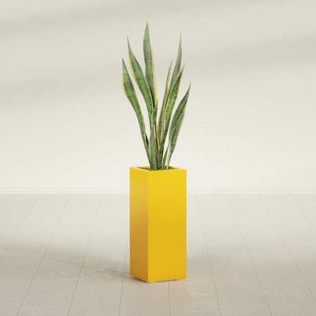 Perth Corner fiberglass planter in Gloss Saffron, planted, in a sunlit interior