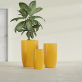 Lisbon Tall Round fiberglass planter in Gloss Saffron, size range, in a sunlit interior